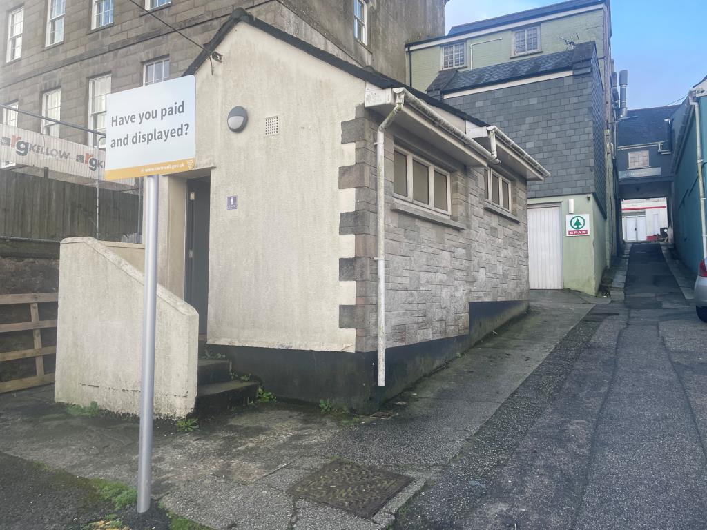 Lot: 140 - FORMER PUBLIC CONVENIENCES - Exterior of toilet block showing steps leading to gents toilet cubicle